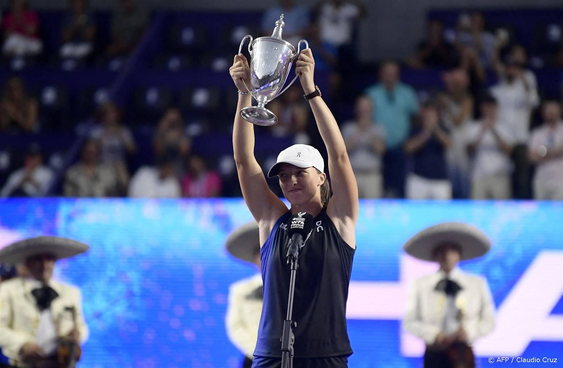 2023-11-07 01:30:31 Poland's Iga Swiatek raises her trophy on the podium after winning the WTA Finals Championship women's singles final tennis match in Cancun, Mexico on November 6, 2023. 
CLAUDIO CRUZ / AFP